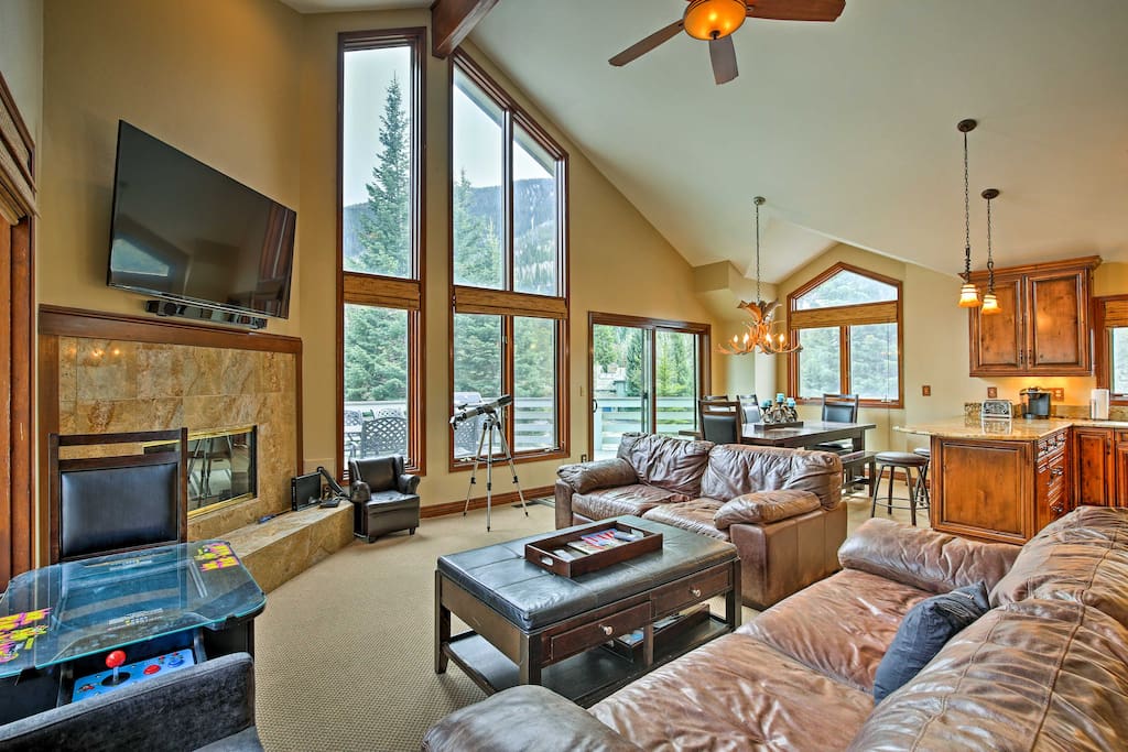 The interior is lined with tall windows to bring the alpine backdrop indoors.