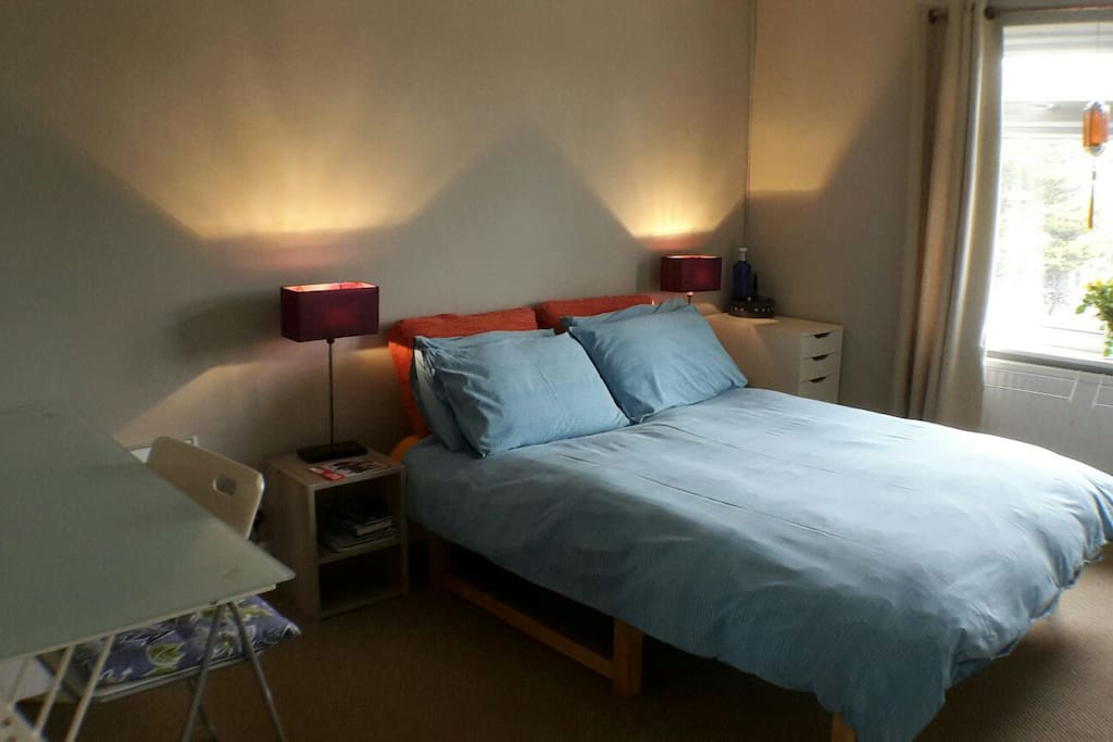 Bedroom with plenty of cupboard space and a desk.
