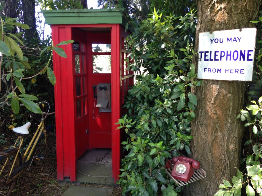 Old New Zealand Memorabilia is scattered around the garden like tis old Phone Box