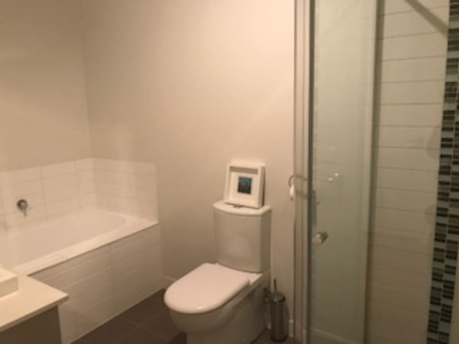 Private bathroom with bath and shower