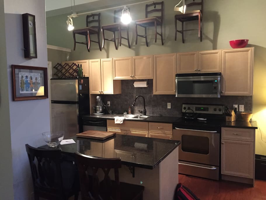 Fully equipped kitchen and island that seats two.