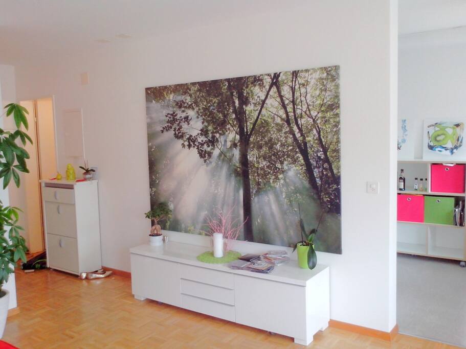 Living room, view from sofa. Kitchen to the right. Bathroom to the left. Modern, relaxing atmosphere.