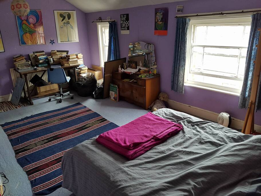 A desk, a set of drawers and two windows with beautiful examples of the Belle Vue