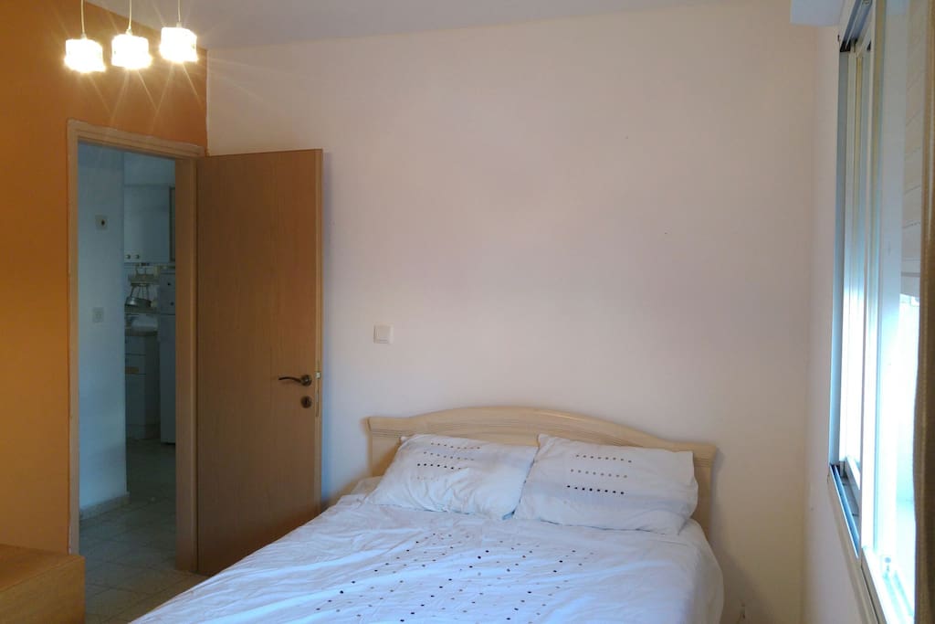 Bedroom with double bed, wardrobe and chest of drawers