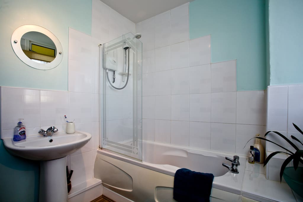 Light airy bathroom with bath and shower