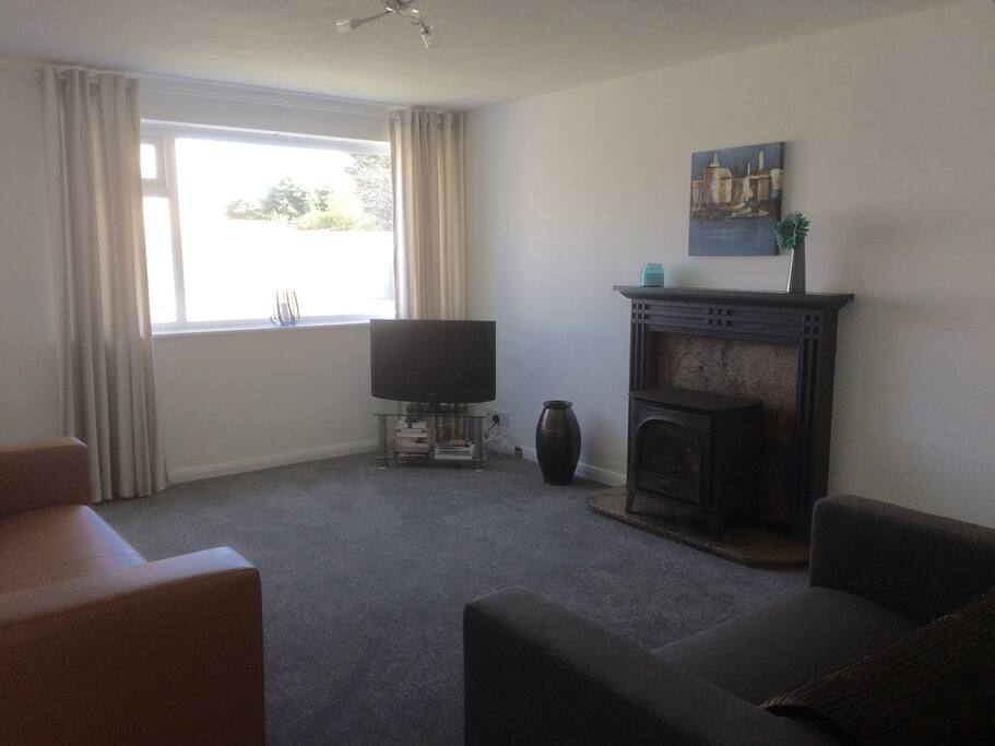 Light and airy open plan lounge with gas fire.