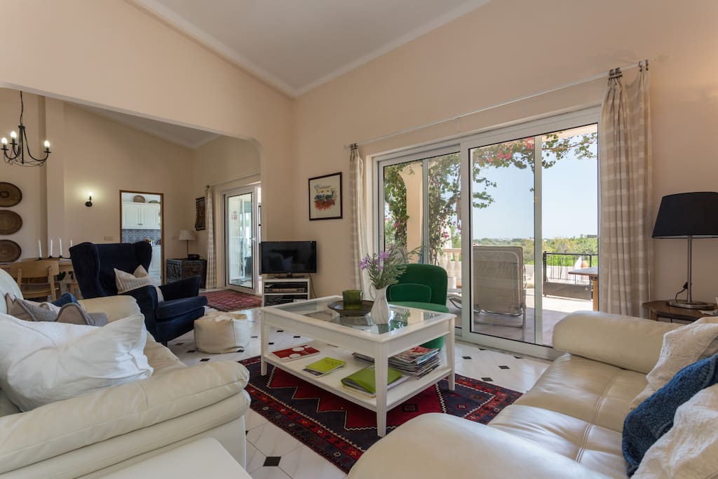 The large living room opens straight onto the patio, with a view of the sea.