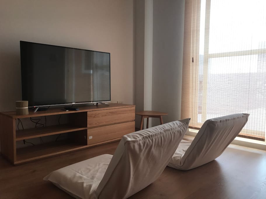 Another room for guest. TV, Wifi, two Japanese chairs, one side table. Outside is a big terrace.