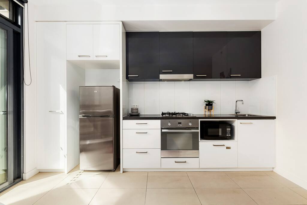 Modern Kitchen with Stone benchtop and dishdraw