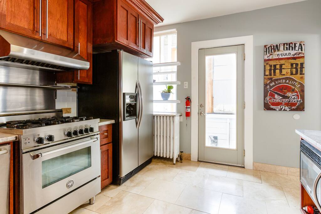 Kitchen with professional gas stove, filtered water and ice maker on the front of the refrigerator
