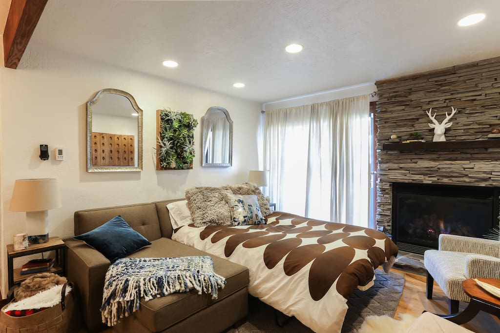 Living Room w/ Gas Fireplace, Wall Mounted 49" Smart TV (Netflix, Hulu & Chromecast), Sofabed (Size: Full) and Patio Access (Through Sliding Glass Doors)
