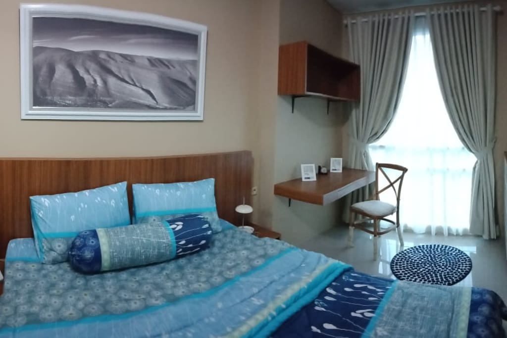 Double bedroom with working space and natural light
