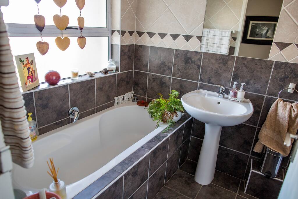 Guest bathroom with its own bath and shower