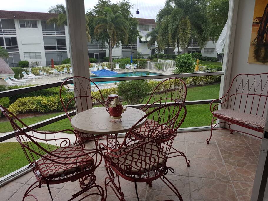 Spacious balcony and sitting area with pool views.