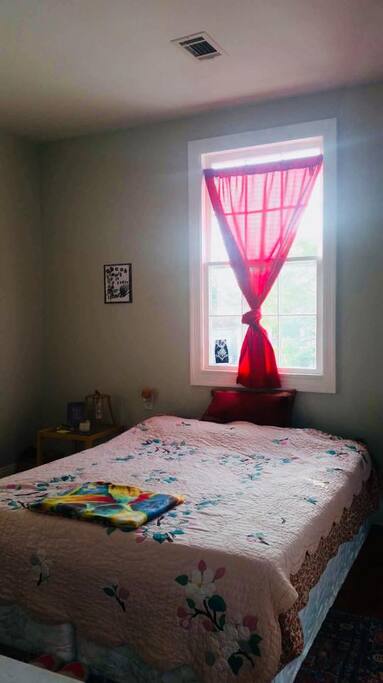 The upstairs bedroom has a ton of natural light. All windows have curtains and the bed is a queen.