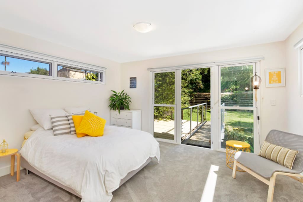 Lightfilled bedroom with queen size bed