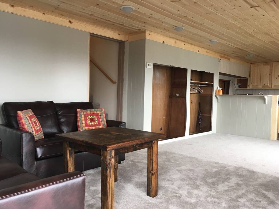 Both love seats pull out into twin-size beds. The coffee table is by local craftsman Seth Minyard of Minyard Reclaimed Woodcraft.