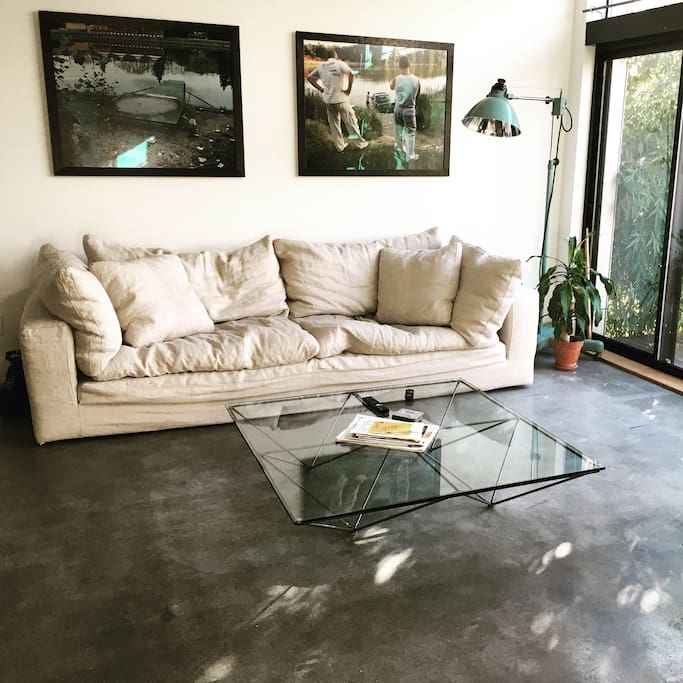 Large pillowy couch and designer coffee table.
