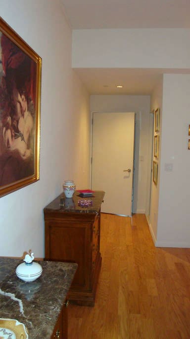 Bedroom view of two dressers and door into the bedroom.