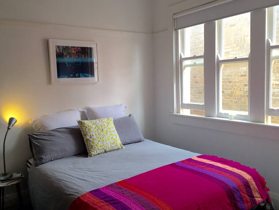 Bedroom with large built-in wardrobe and ceiling fan