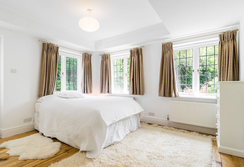 Bedroom with garden and woodland views.