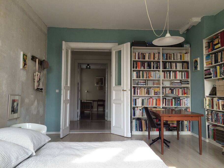 Work desk in bedroom with view into entrance and living space