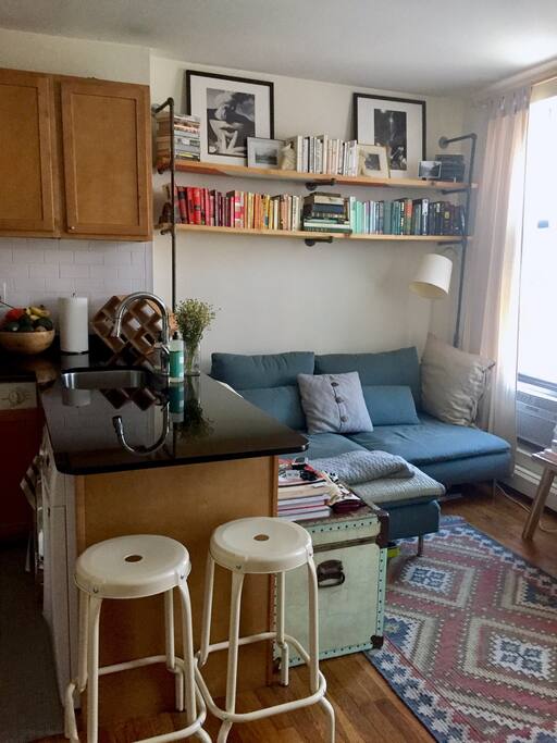 Part of kitchen counter and living room couch