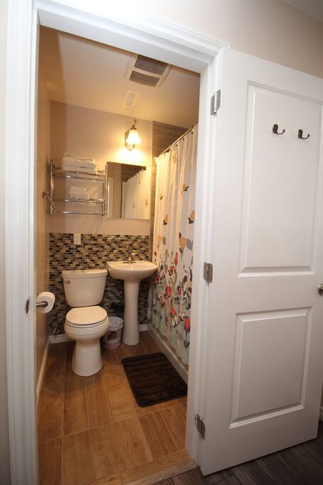 The bathroom with a shower and bathtub.