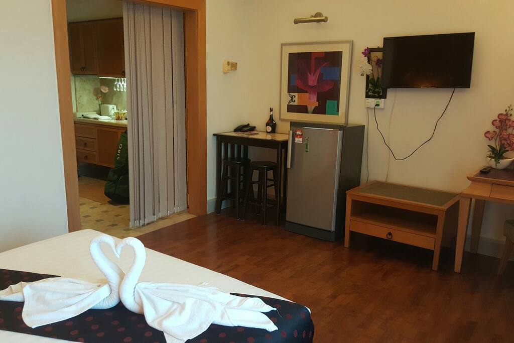 The unit has a wrting desk, TV, refrigerator, microwave oven, stove and utensils