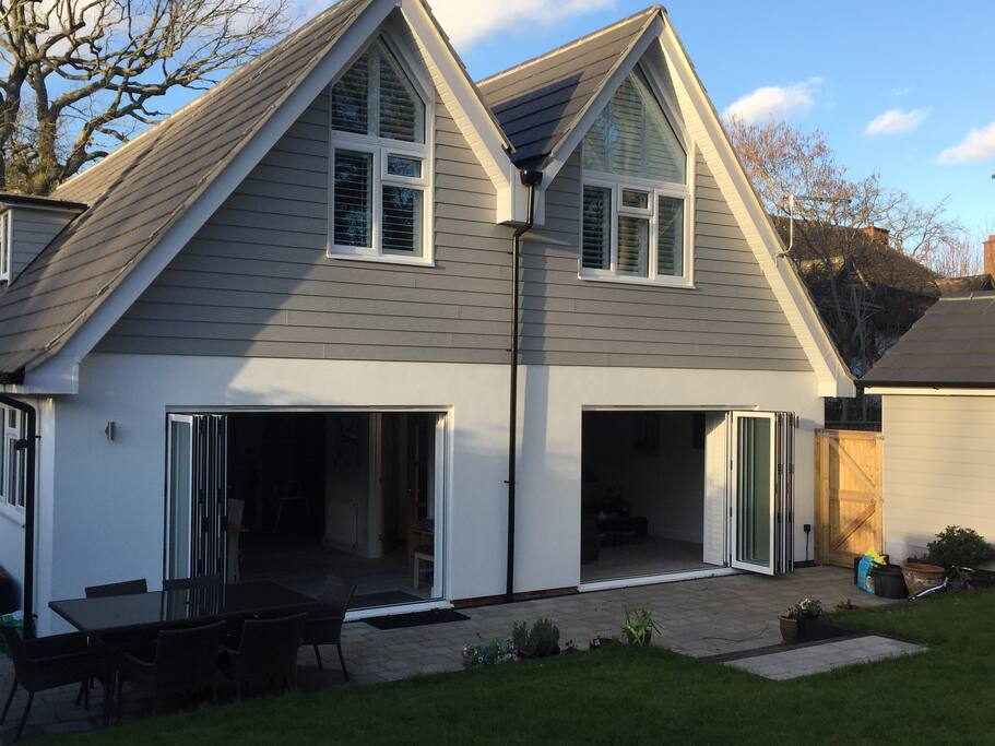 Full width bi-fold doors across the house expand the living space