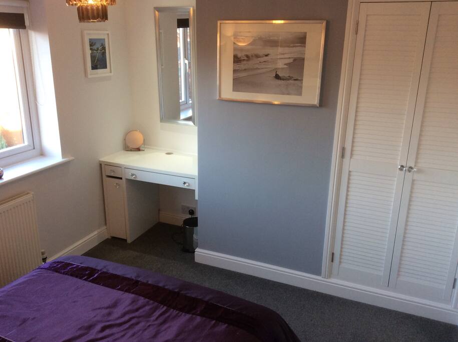 Wardrobe and desk/dressing area within Bedroom