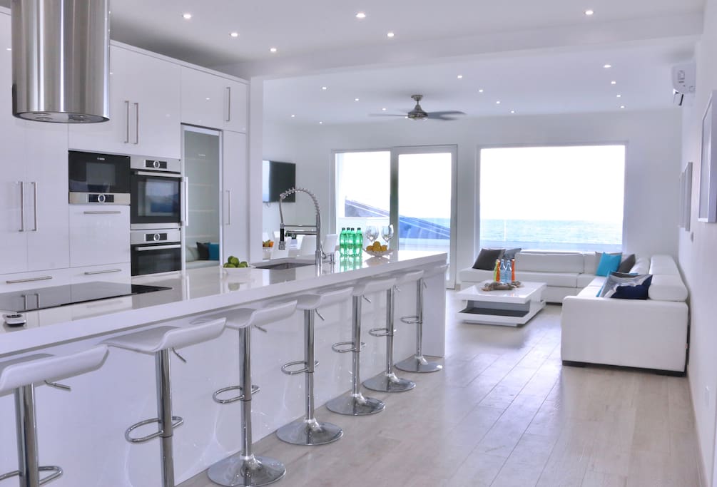 Oversized gourmet kitchen island with living space and sea views