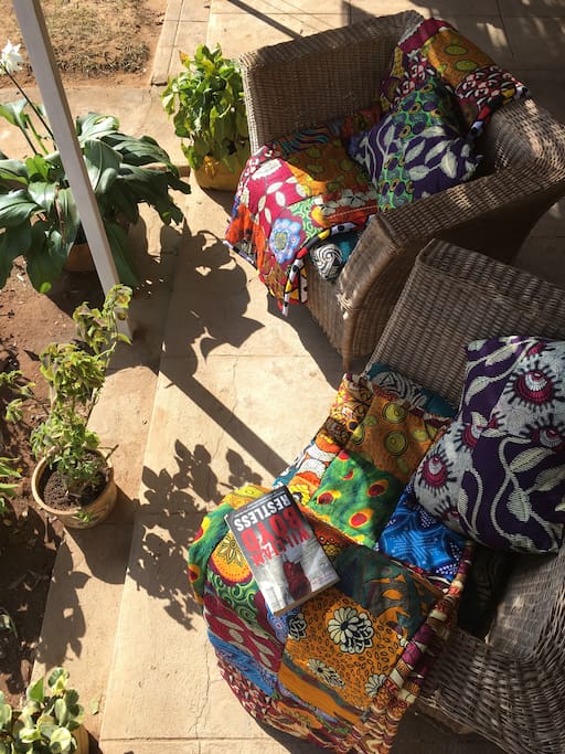 Locally made cane chairs decorated with traditional Malawian fabrics sit on the Khondi, where you can look over the Kasungu mountains and watch the fields in the distance