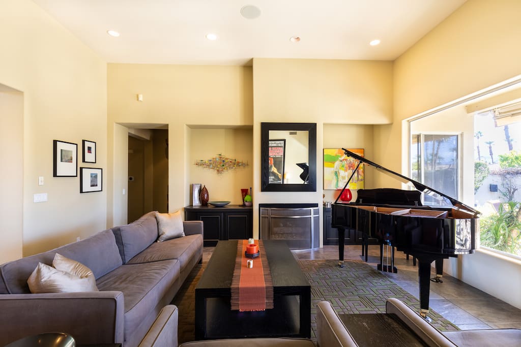 Yamaha baby grand anchors the living room--plenty of seating and easy to light gas fireplace with "ember-ific" logs!