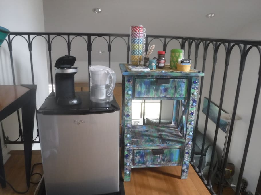 Guest fridge with cold filtered water. Single cup coffeemaker, coffee and tea.