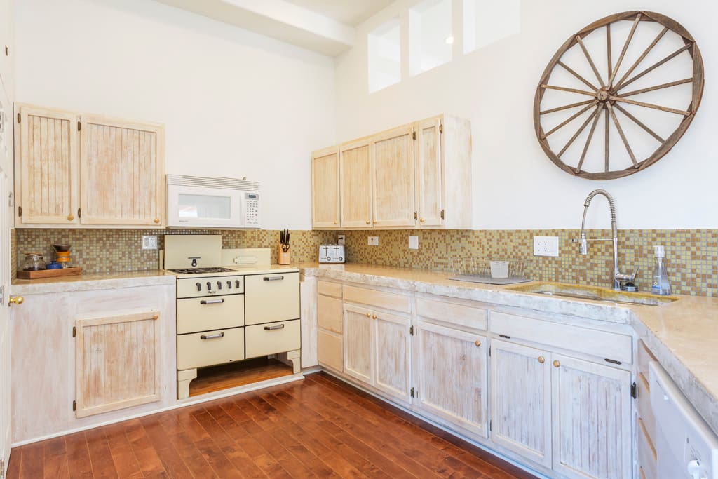 Large, fully-stocked kitchen has everything you need to cook a nice meal. Check out the reclaimed wagon wheel on display :)