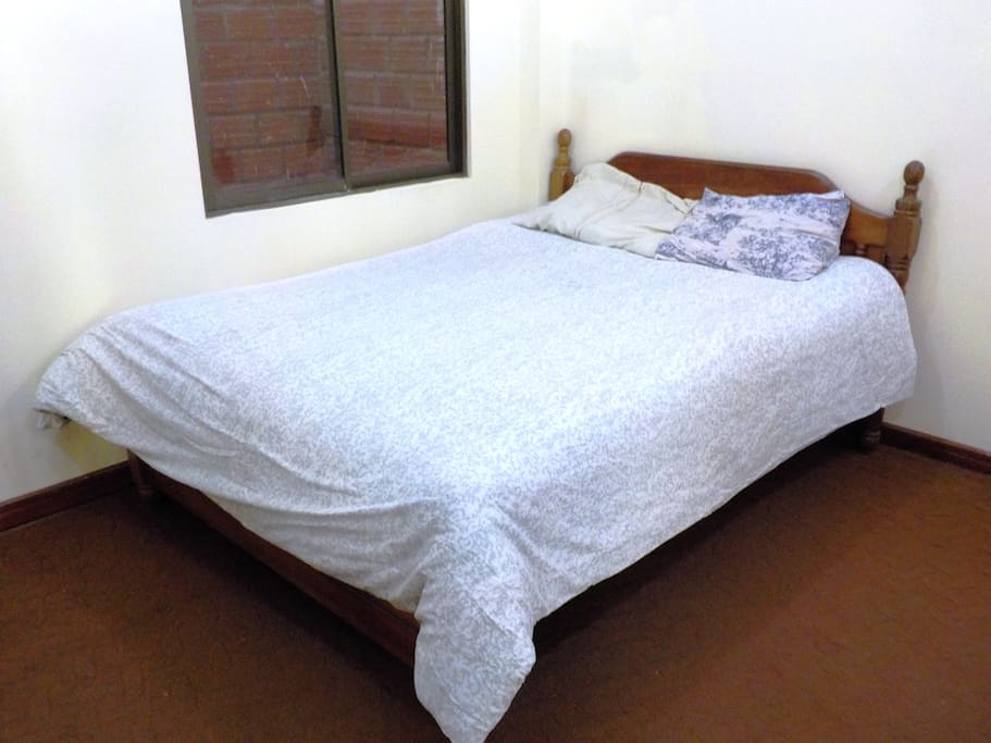 Queen size bed with soft mattress and warm blankets