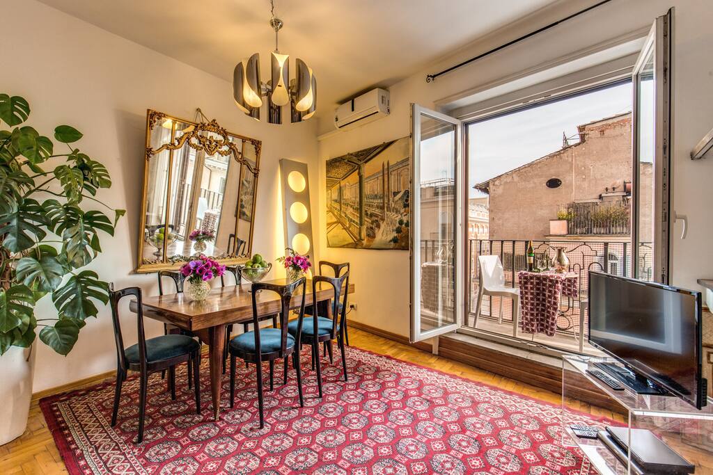 Living Room ORIGINAL ARTPIECES with turkish rugs and plasma, sofa bed and terrace. french table from the 30's