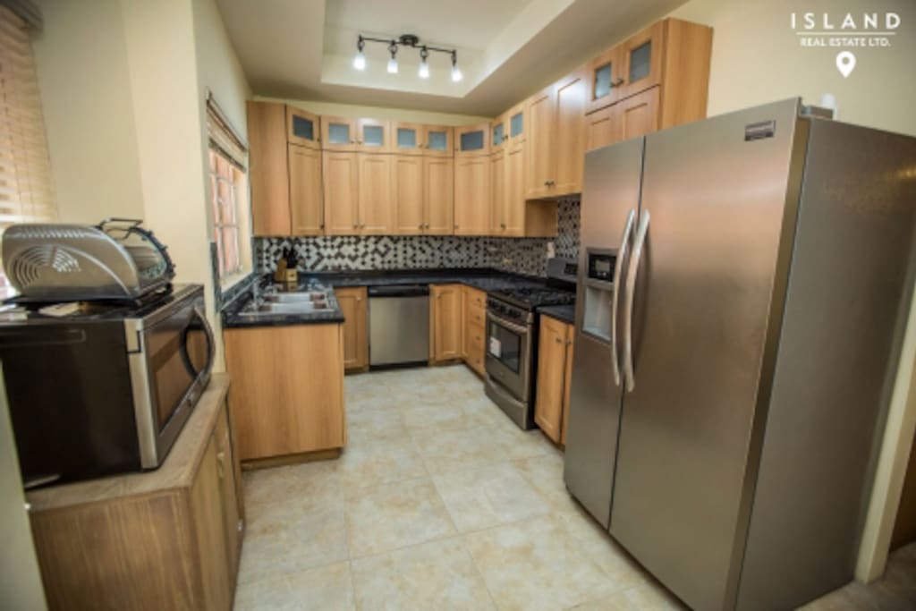 Complete fully furnished kitchen with new stainless steel appliances and kitchen utensils.