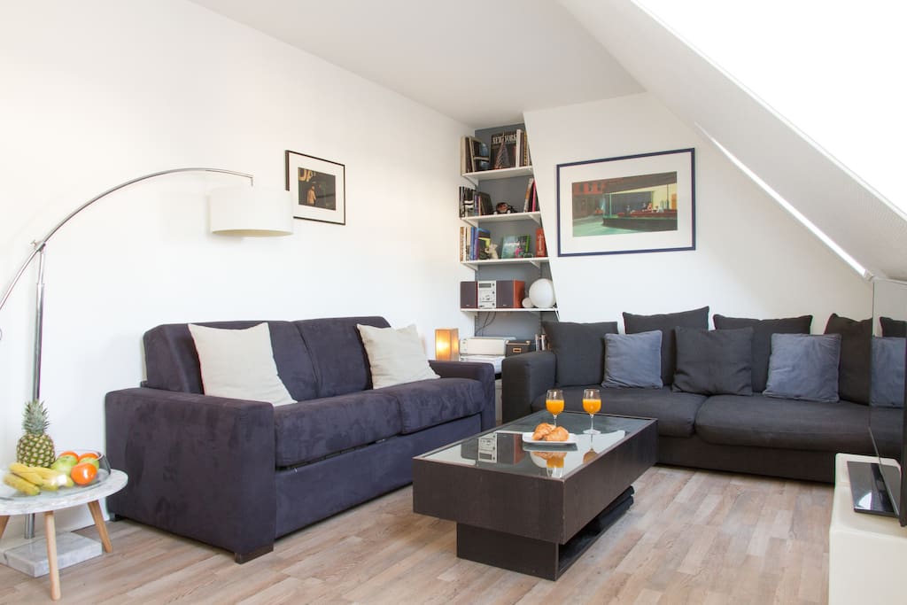 The cosy living area features a sofa bed, second couch, coffee table, flat-screen TV and more