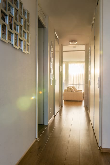 Hall from entrance door to living room and glass doors to the balcony