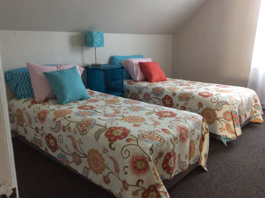 Twin beds with 2 charging stations ( plugs!) and a sunny window which now has black out curtains so you can sleep through the morning sun!!