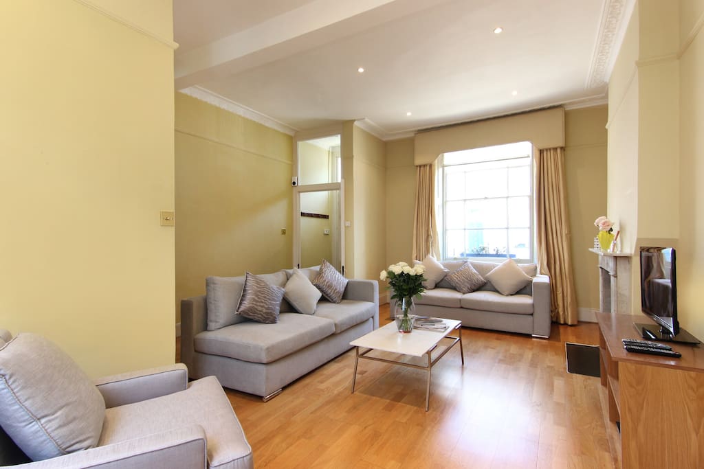The light, spacious lounge with 2 great sofas, chairs, fireplace, flat screen TV, Freeview channels and Free WiFi
