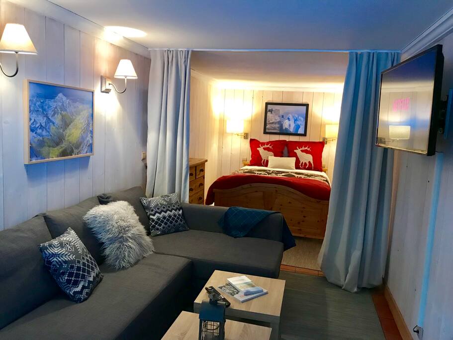 warm and cozy bedroom with sitting/additional sleeping area