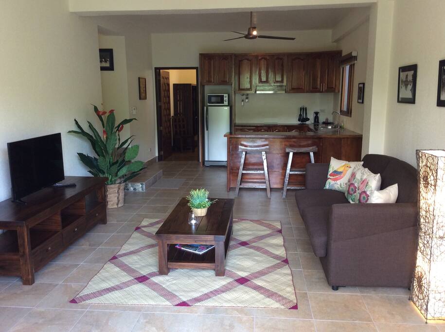 View inside the Villa showing living room with queen sofa lounge and the kitchen