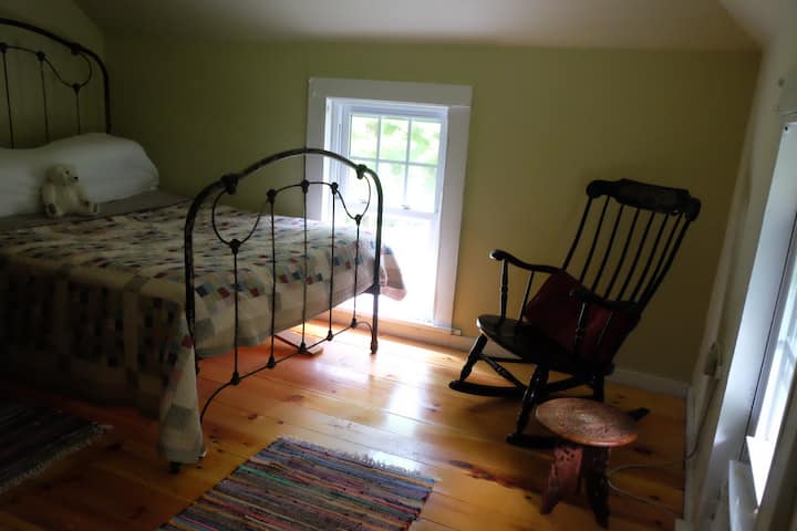 Bedroom with full size bed and rocking chair