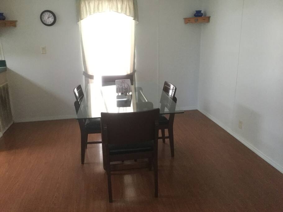 Glass dining table seats four