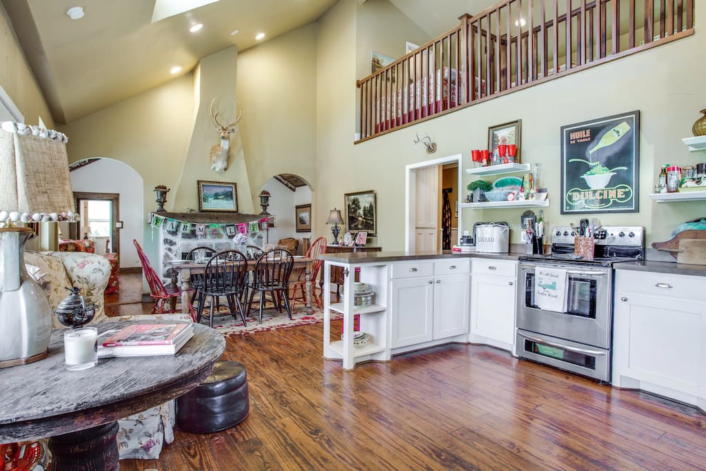 A well equipped kitchen with a fireplace in the dining room.