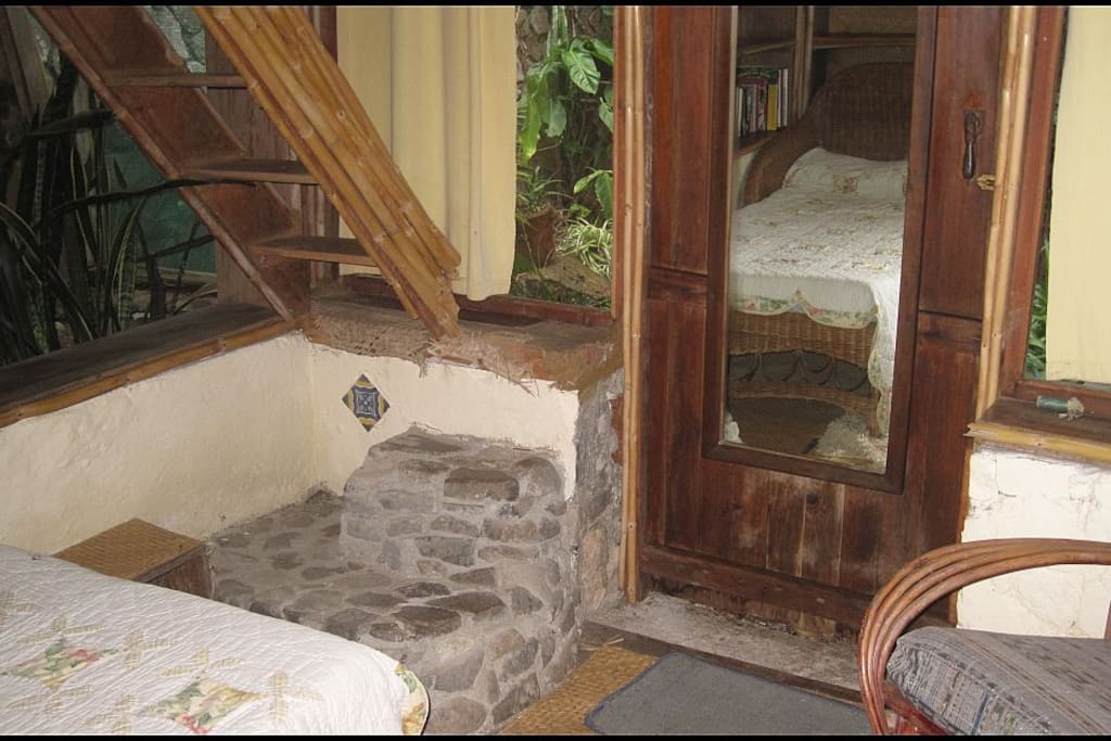 Living area with ladder/steps to bed on platform above