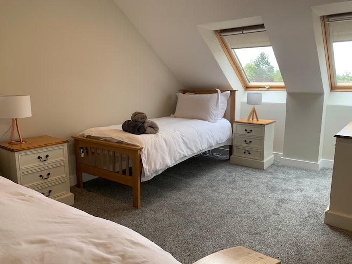 Dormitorio doble en la planta superior con vistas a las azoteas y hacia el Parque Nacional Cairngorms